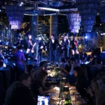 Blue-lit dinner show with live entertainment and guests dining at Philipp's Club Milano