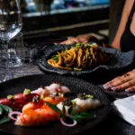 Gourmet pasta dish served alongside other plated dishes at Philipp's Club Milano