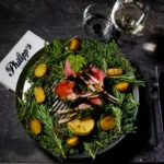 Fresh gourmet salad with leafy greens, colorful vegetables and grilled ingredients served at Philipp's Club Milano