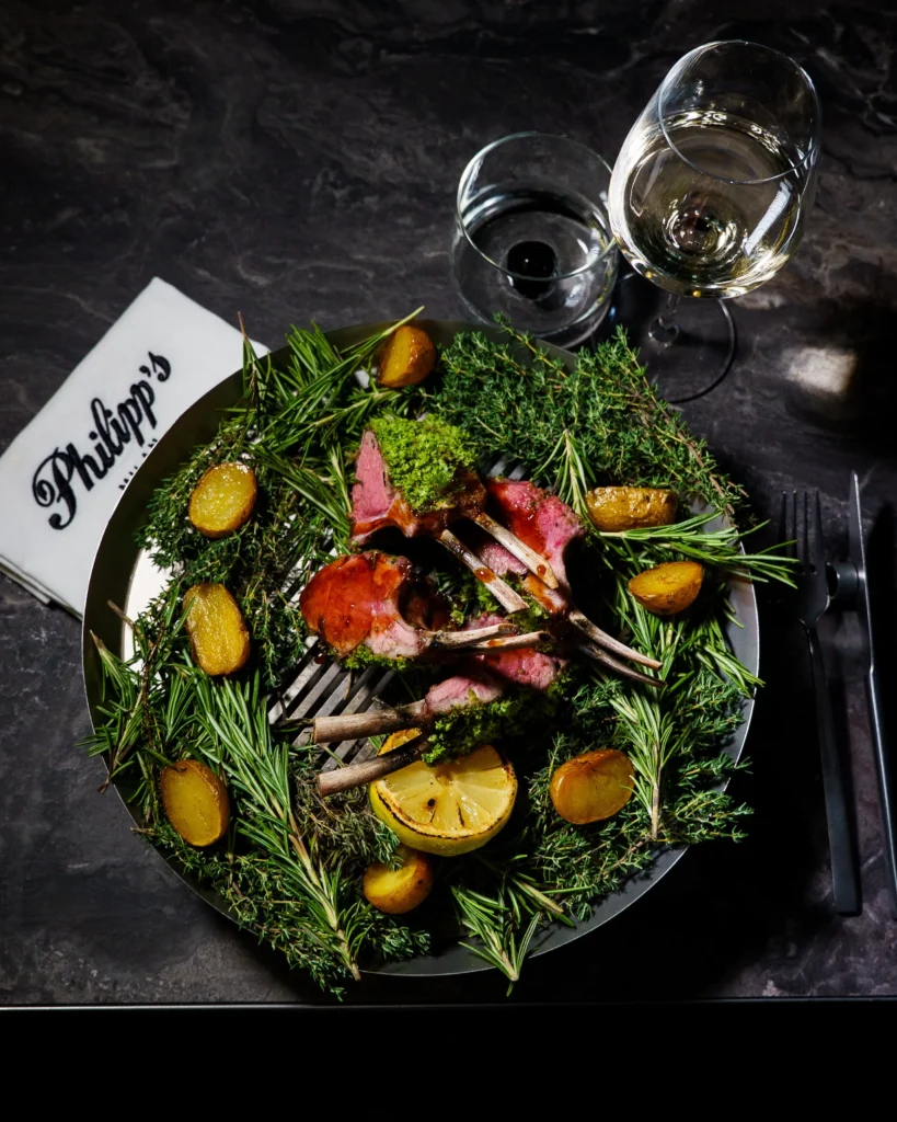 Fresh gourmet salad with leafy greens, colorful vegetables and grilled ingredients served at Philipp's Club Milano