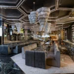 Luxury dining lounge with plush seating, sculptural ceiling lights and sophisticated decor at Philipp's Club Milano
