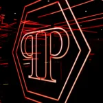 Red neon geometric emblem and stylized lettering on a dark wall at Philipp's Club Milano