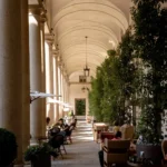 Elegant outdoor dining tables beneath the historic vaulted colonnades at Portrait Milano