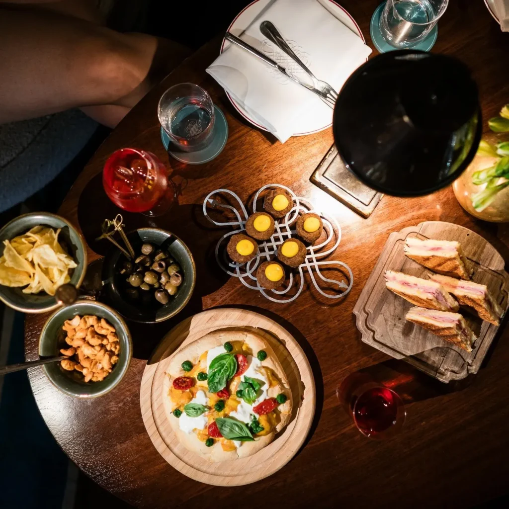 Overhead view of a fine dining table with gourmet dishes, wine glasses and elegant tableware at Portrait Milano