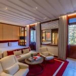 Garden studio deluxe suite at Portrait Milano featuring a comfortable lounge, contemporary furnishings and large windows overlooking greenery