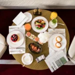 Breakfast spread with pastries, fresh fruit, coffee and plated dishes arranged on a table at Portrait Milano