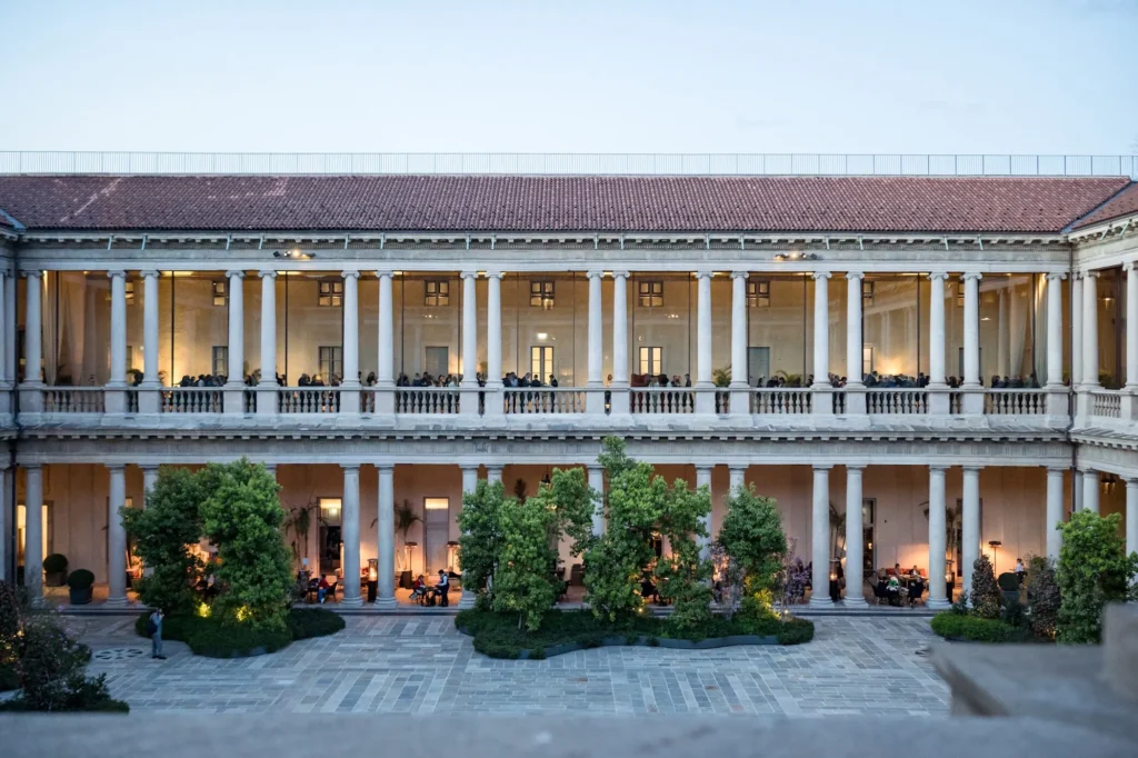 Historic facade and landscaped entrance courtyard of Portrait Milano luxury hotel in Milan