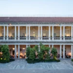 Historic facade and landscaped entrance courtyard of Portrait Milano luxury hotel in Milan