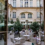 Charming courtyard terrace with outdoor tables and greenery at Rosewood Hôtel de Crillon Paris