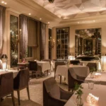 Elegant dining room with warm lighting and sophisticated furnishings at Rosewood Hôtel de Crillon Paris