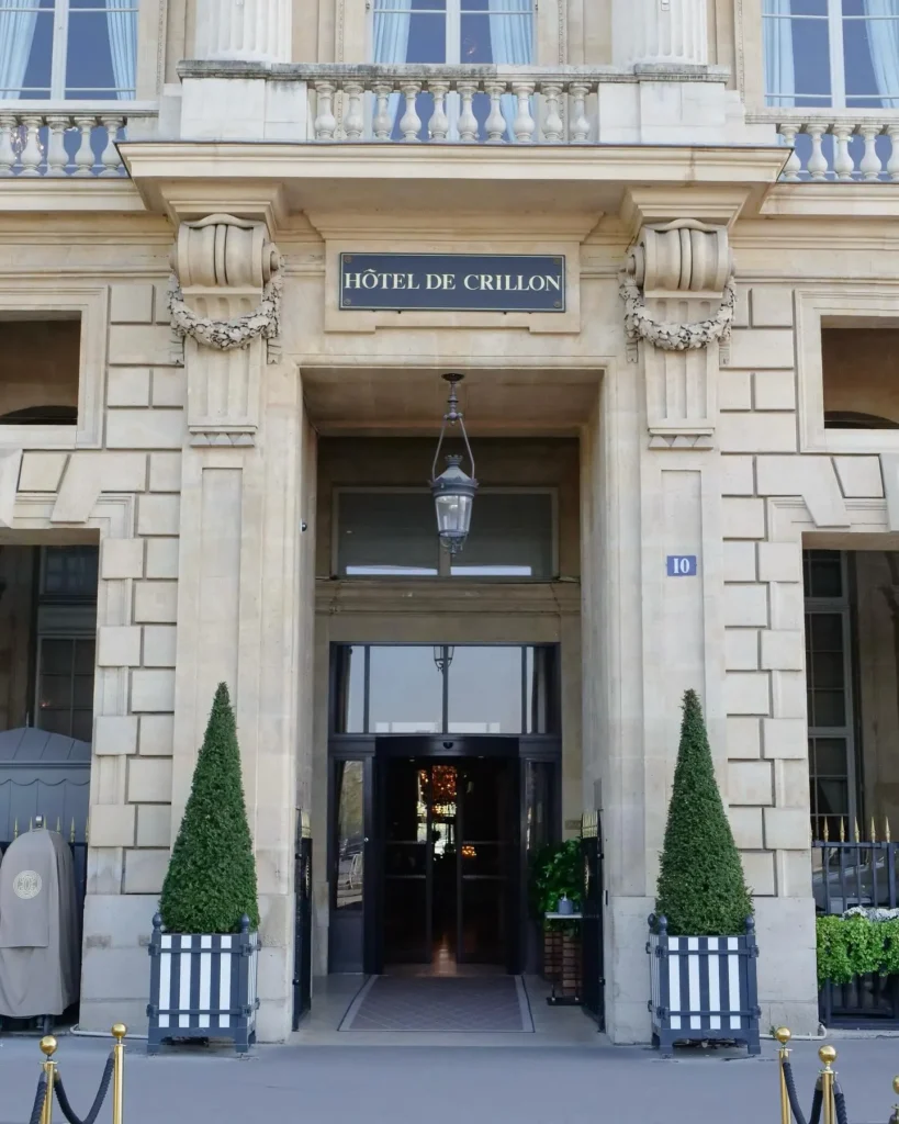 Grand stone entrance of Rosewood Hôtel de Crillon Paris framed by classic French architecture