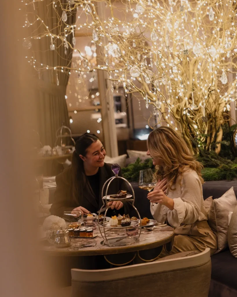 Guests enjoying an intimate dinner beneath decorative lights at Rosewood Hôtel de Crillon Paris