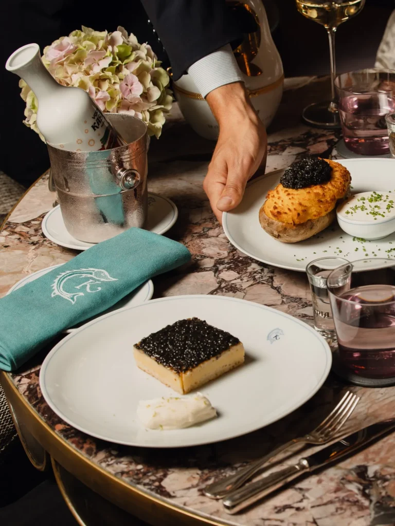 Chef presenting an elegant gourmet dish at Rosewood Hôtel de Crillon Paris