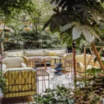 Peaceful garden terrace with cushioned seating and lush greenery at Rosewood Hôtel de Crillon Paris