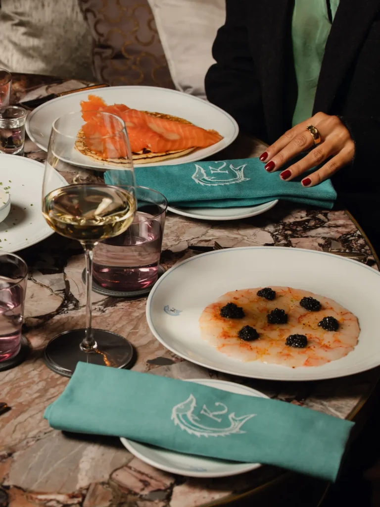 Gourmet seafood dishes presented on elegant tableware at Rosewood Hôtel de Crillon Paris