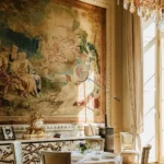 Elegant restaurant dining area with a historic mural and refined table settings at Rosewood Hôtel de Crillon Paris