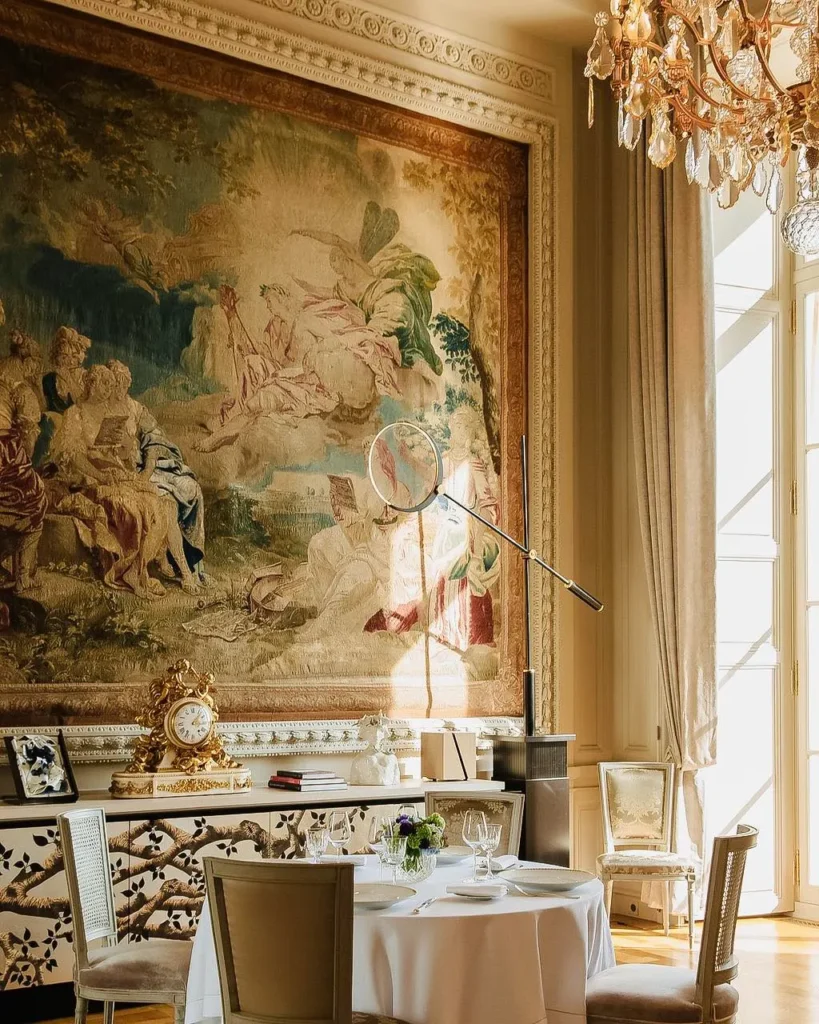 Elegant restaurant dining area with a historic mural and refined table settings at Rosewood Hôtel de Crillon Paris
