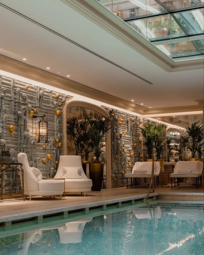 Indoor spa pool surrounded by elegant stone finishes and softly illuminated interiors at Rosewood Hôtel de Crillon Paris