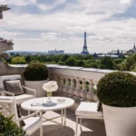 Outdoor terrace with elegant seating and views toward the Paris skyline at Rosewood Hôtel de Crillon