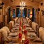 Rustic alpine dining table arranged with candles, warm wooden interiors and an inviting dinner setting