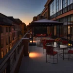 Outdoor terrace of The Carlton Milan Presidential Suite featuring elegant seating, warm architectural lighting, and views across surrounding rooftops